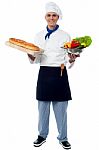 Chef Holding Fresh Vegetables And Bread Stock Photo