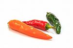 Colored Peppers Over White Background Stock Photo