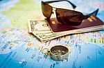 Compass, Passport, Money And Sunglasses On The Map Stock Photo