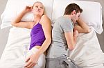 Couple Lying In Bed After Argument