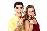 Couple Posing With Pizza Slice, About To Eat Stock Photo