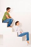 Couple Sitting On Stairs Stock Photo