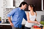 Couple Staring Each Other Eyes In The Kitchen Stock Photo
