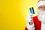 Cropped Image Of Aged Santa Holding Credit Card Stock Photo