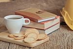 Cup Of Coffee And Cracker With Book On Old Wood Table Stock Photo
