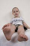 Cute Boy Raising His Legs Stock Photo