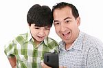 Dad And Son Reading Sms Stock Photo