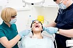 Dental Cleaning, Woman Under Treatment Stock Photo