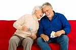 Elderly Couple Holding Money