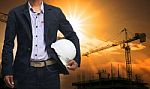 Engineer Man Standing With White Safety Helmet Against Beautiful Stock Photo