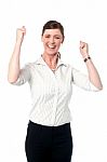 Excited Corporate Lady With Clenched Fists Stock Photo