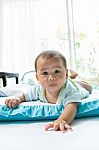 Face Of Little Baby Lying On Children Bed In Home Living Room Stock Photo