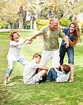 Family Holding Back Grandfather Stock Photo