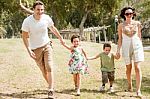 Family Running With Two Young Children Stock Photo