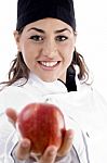 Female Chef Showing Red Apple Stock Photo