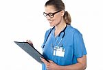 Female Doctor Holding A Clipboard Stock Photo