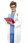 Female Doctor With A Case File In Her Hand Stock Photo