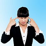 Female Employee Covering Her Ears Stock Photo
