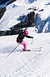 Female Skier In Fresh Powder Snow And Skiing Huts Stock Photo