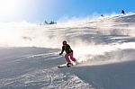 Female Skier In Fresh Powder Snow And Sunlight Stock Photo