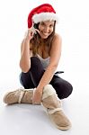 Female Wearing Christmas Hat And Talking On Mobile Stock Photo