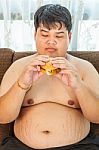 Ffat Man Eating Hamburger Seated Stock Photo