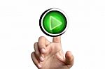 Finger Pushing Play Button Stock Photo