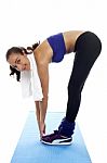 Fit Woman Bending Over And Touching Her Toes Stock Photo