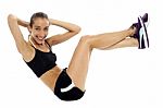 Fit Woman In Sporty Attire Doing Crunches Stock Photo