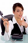 Front View Of Happy Businesswoman Pointing At Phone Stock Photo