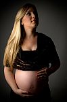 Front View Of Pregnant Female Looking Up Stock Photo