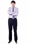 Full Length Shot Of Businessman With Folded Arms Stock Photo
