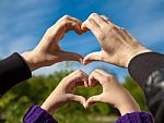Girl And Her Mother Show Sign Of Heart With Their Hands Stock Photo