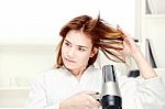 Girl Drying Her Hair At Home Stock Photo
