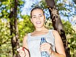 Girl In Forest Holding Bottle Of Water Stock Photo