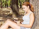 Girl In Park With Tablet Computer Stock Photo