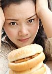 Girl Thinking With Hamburger Stock Photo