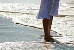 Girl's Legs On The Beach Stock Photo