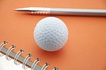 Golf Ball On Notebook Stock Photo