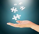 Hand Holding Puzzle Pieces Stock Photo