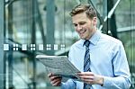 Handsome Businessman Reading A Newspaper Stock Photo
