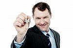 Happy Businessman Holding A House Key Stock Photo