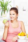 Happy Woman At Home With Fruits Stock Photo