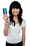 Happy Young Woman Showing Credit Card Stock Photo