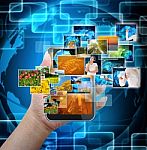 Holding Mobile Smart Phone With World Technology Background Stock Photo