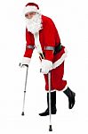 Injured Santa Walking With Help Of Crutches Stock Photo