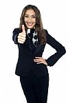 Joyous Young Stewardess Gesturing Thumbs Up Stock Photo