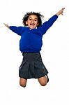 Jubilant School Kid Jumping High Up In The Air Stock Photo