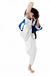 Karate Girl Kick A Leg Stock Photo