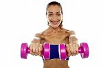 Lady Lifting Dumbbells, Arms Outstretched Stock Photo